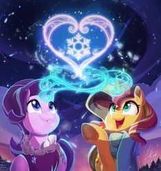 two ponies standing next to each other in front of a heart shaped snowflake