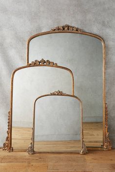 two mirrors sitting on top of a wooden table