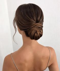 a woman with her hair in a low bun