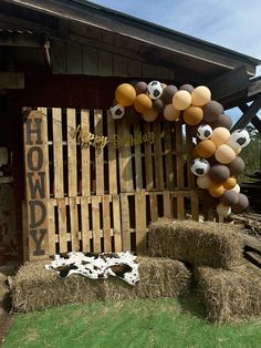 hay bales are stacked on top of each other in front of a building