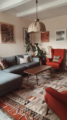 a living room with couches, chairs and rugs on the floor in front of a window