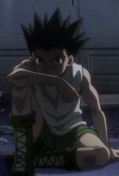 an anime character sitting on the ground with his arms crossed