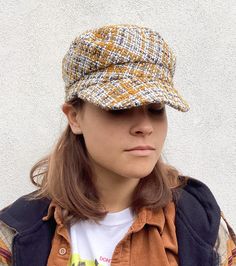 This tweed recycled wool cap in colours of yellow ochre, grey and cream will add style to any outfit. It is fully lined in brown cotton and has an inner cotton moleskin band for comfort. Size M to fit head size 57cm/22.5 inches * Dry clean only To see more of my hats please click https://www.etsy.com/uk/shop/OverToYou I design, pattern cut and create all my hats in sunny Brighton in the South of England. All my designs are original and combine timeless elegance with a modern twist. I despatch my Cotton Cap For Fall, Cotton Flat Cap For Fall, Brown Cloche Cap For Fall, Trendy Yellow Hats For Fall, Brown Fall Cloche Hat, Trendy Yellow Fall Hat, Trendy Yellow Fall Hats, Brown Cotton Hat For Fall, Brown Tweed Cap