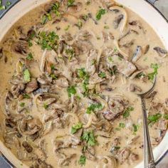 a pan filled with mushroom soup and garnished with parsley