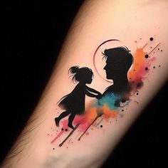 a tattoo on the arm of a girl and boy holding hands with watercolor splashs