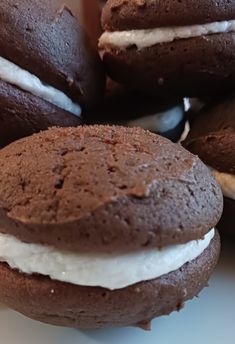 several chocolate cookies with white frosting on them