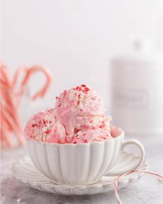 a white bowl filled with ice cream next to candy canes