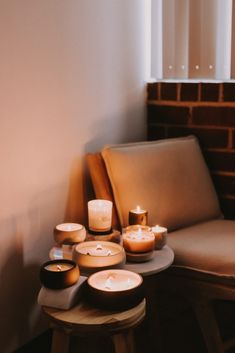 candles sit on a table next to a couch