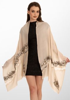 This beige scarf, woven from the finest cashmere, is a distinctive and unique accessory. There are several hand crafted elements that make it unique starting with a tonal beige floral embroidery elevated by a black border, striking gold beadwork and a shiny beige filigree lace cut-out panel in a diagonal pattern. This luxurious scarf seamlessly marries comfort with chic detailing, making it a versatile piece for any occasion. Whether for casual outings or special events, the intricate craftsmans Beige Scarf, Lace Panelled, Cashmere Scarf, Black Border, Accessories Unique, Floral Embroidery, Bead Work, Special Events, Cut Out