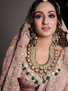 a woman in a bridal outfit with jewelry on her face