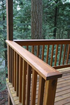 a wooden deck in the woods with trees