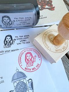 a rubber stamp that is on top of some paper and has a wooden object in it