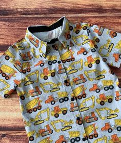 This is the perfect shirt for that construction truck loving boy!  Whether your toddler loves dump trucks or front loaders or any kind of construction vehicle! It's a perfect gift for a birthday party and for everyday, too!   Straight hem with side vents. Shirt closures are snaps for ease in dressing and the neck is a comfortable "relaxed fit".  Available in short sleeves only in woven cotton. FINISHING:  All creations from Little Giggle Shop have been handmade in a smoke-free home with a Grandm Toddler Construction Birthday Party, Construction Birthday Party, Truck Theme, Toddler Boy Gifts, Truck Shirt, Second Birthday Ideas, Construction Trucks, Grandmothers Love, Construction Vehicle