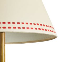 a red and white lamp shade on a table