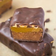 three pieces of chocolate and peanut butter bars stacked on top of each other with one bite taken out