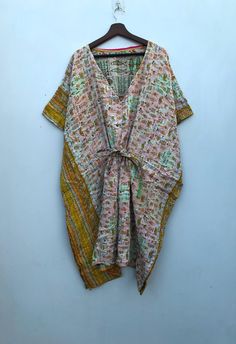 A vintage Kantha kaftan sounds like a beautiful fusion of cultural heritage and fashion. Kantha is a traditional embroidery technique from the Indian subcontinent, particularly prevalent in West Bengal and Bangladesh, where layers of old saris and dhotis are stitched together to create new textiles. Kaftans, on the other hand, have a long history in various cultures, often associated with loose, flowing garments worn in many parts of the world. Combining the two, a vintage Kantha kaftan would li Multicolor V-neck Kaftan With Batik Print, Bohemian Multicolor Ikat Print Kurta, Multicolor Bohemian Kurta With Ikat Print, Bohemian Multicolor Kalamkari Maxi Dress, Hippie V-neck Free Size Kaftan, Multicolor Boho Print Kaftan With Kimono Sleeves, Multicolor Batik Print Kimono For The Beach, Long Bohemian Block Print Kimono, Multicolor Bohemian Kaftan With Kimono Sleeves