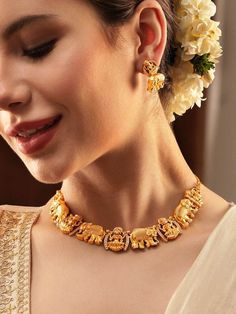 This jewellery set consists of a necklace and a pair of earrings Gold-plated necklace, has white AD stone-studded Lakshmi and elephant design textured details Secured with a hook closure A pair of matching drop earrings, each secured with a post-and-back closure Size & Fit Necklace: 13 cm Earrings : 3 cm each Material & Care Material: Brass Plating: Gold-plated Stone Type: American Diamond Care Instruction Wipe your jewelry with a soft cloth after every use Always store your jewellery in a flat box to avoid accidental scratches Keep sprays and perfumes away from your jewelry Do not soak your jewellery in water Clean your jewelry using a soft brush, dipped in jewelry cleaning solution only Dispatch within 7 days Luxury Gold Sets With Motifs, Lakshmi Gold Necklace, Jewelry Cleaning, Jewelry Cleaning Solution, Designer Necklace, Elephant Design, Stone Studs, Jewelry Choker, Jewellery Set