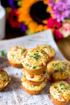 several small muffins stacked on top of each other with flowers in the background