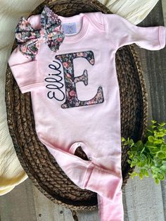 This sweet personalized baby sleeper is soft and comfortable to snuggle a little one. This custom outfit makes a perfect coming home outfit, newborn pictures, or baby shower gift. This features a soft pink romper, a large initial in a simplistic vintage floral of bold pinks and purples with name in a  down the side of the intial. Preemie 5-7lbs (mis-tagged as newborn) Newborn fits approximately 6-8lbs 0/3 fits approximately 9-13lbs 3/6 fits approximately 12-16lbs Please leave name in the notes t Personalized Fitted Pink Onesie, Fitted Pink Onesie With Name Print, Pink Fitted Onesie With Name Print, Personalized Fitted Cute Onesie, Personalized Fitted Onesie For Spring, Baby Sleeper, Outfit Baby Shower, Pink Romper, Baby Sleepers