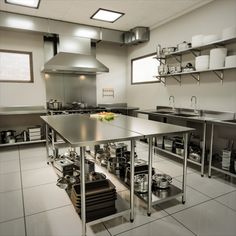 an industrial kitchen with stainless steel appliances and counters