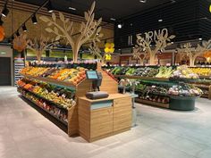 an empty grocery store filled with lots of fresh fruits and veggies on display