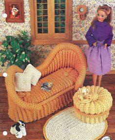 a doll standing next to a couch in a living room with cats on the floor