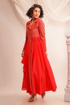 Coral biker anarkali with textured pattern and thread embroidery in geometric pattern. Paired with pant.
Component: 2
Pattern: Embroidery
Type Of Work: Geometric, thread
Neckline: Notched lapel collar
Sleeve Type: Full sleeves
Fabric: Silk Chanderi, Cotton Slub
Color: Coral
Other Details: 
Side tassel detailing
Closure: 
Anarkali: Front zipper
Occasion: Sangeet - Aza Fashions Long Salwar Kameez With Resham Embroidery For Reception, Chanderi Sharara Designer Wear, Chanderi Sharara For Designer Wear, Chikankari Embroidery Maxi Set For Reception, Silk Chikankari Embroidery Floor-length Kurta, Silk Kurta With Chikankari Embroidery, Floor-length, Floor-length Kurta With Dabka Work For Reception, Long Sharara With Resham Embroidery For Transitional Season, Floor-length Cotton Silk Kurta For Eid