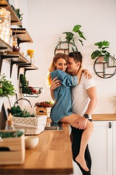 a man and woman hugging in the kitchen