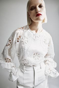 Springtime sophistication. The Rosalee Lace Blouse features an effortless relaxed fit with long volume sleeves, an elasticated frill cuff, high round neckline and allover embroidery details.SIZING: Relaxed fit. AU: Model wears a size 8 / US: Model wears a size 4.FABRICATION: Main base: 100% polyester. Main embroidery: 100% polyester. Lining: 100% cotton. Exclusive of trims.  - Volume sleeves - Elastic frill cuff - Embroidered detail Spring Long Sleeve Blouse With Set-in Sleeves, Fall White Blouse With Elastic Sleeves, White Blouse With Elastic Sleeves For Fall, Chic White Blouse With Elastic Sleeves, Long Sleeve Tops With Embroidered Sleeves For Work, White Long Sleeve Tops With Gathered Sleeves, White Bishop Sleeve Tops With Floral Embroidery, White Tops With Floral Embroidery And Bishop Sleeves, White Bishop Sleeve Blouse For Spring