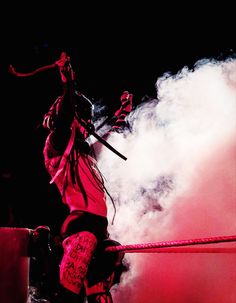 a man standing on top of a wrestling ring