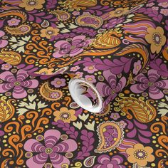 a purple, orange and yellow paisley print fabric with white ring on the end of it