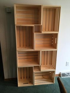 an empty wooden shelf in the corner of a room