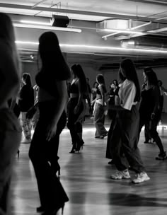 a group of people dancing in a large room