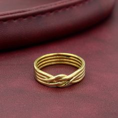 a gold ring sitting on top of a red bag