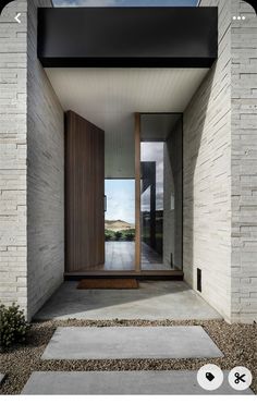 the entrance to a modern house with stone steps leading up to it's front door