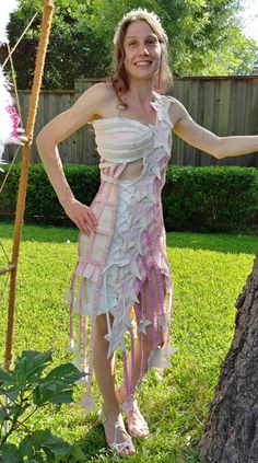 "RECYCLE WEDDING DRESS - TP AND TAPE - WOMEN'S DRESS - size EXTRA SMALL/SMALL 'NORTHERN LIGHTS' Made entirely with Quilted Northern toilet paper, all sorts of tape and some glitter glue! (No sewing or thread!) This dress was made April of 2019 for the \"Quilted Northern Wedding Dress Competition.\" The top is one-shoulder and laces up at center bust.  Botton half is connected. The skirt is very stiff, almost like wearing a cast.  Stars are hanging from ruffle strips at hem.  Wrap dress around body and lace up!  *DRESS IS FOR LIMITED WEARING ONLY, CANNOT SIT OR USE TALL STAIRS!* One matching accessory: star head band  Mannequin Measurements: BUST: 33.5\" UNDERBUST: 27.5\" WAIST: 26\" HIPS: 37\" *Item fits a women's size xs-small* Model Measurements: Bust: 32A Waist: 25\" Hip: 36\" Height: 5 Northern Wedding, Recycle Wedding Dress, Sparkle Stars, Book Clothes, Glitter Glue, Recycled Fashion, Matching Accessories, Dress Clothes For Women, Pink Fashion