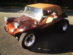 an old car is parked on the side of the road