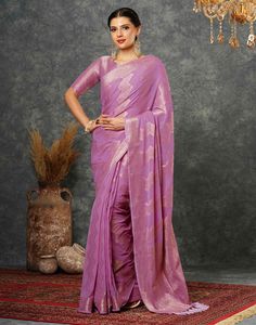 Light Purple Woven Banarasi Georgette Saree  Light Purple Woven Banarasi Georgette Saree is a luxurious and elegant piece. The intricate weaving patterns, often featuring floral motifs or geometric designs, create a rich and textured fabric. The georgette base adds a touch of softness and flowiness, making it comfortable to wear.  Features Of Light Purple Woven Banarasi Georgette Saree  Traditional Handloom Craft  Intricate Gold Brocade Work  Durability and Longevity   Size Fit  The model height Festive Fitted Pre-draped Saree With Zari Weaving, Transitional Brocade Saree For Puja, Brocade Saree For Puja And Transitional Season, Transitional Season Brocade Saree For Puja, Brocade Pre-draped Saree With Pallu For Diwali, Navratri Purple Brocade Traditional Wear, Purple Brocade Traditional Wear For Navratri, Diwali Brocade Handloom Saree, Diwali Handloom Brocade Saree