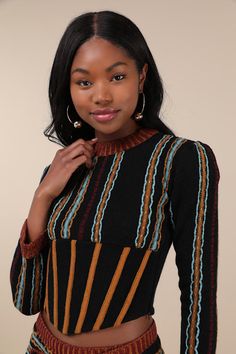 Let your playful side run wild with the help of an adorably eclectic top like the MUTMA Bansho Black Multi Striped Wool-Blend Knit Corset Sweater Top! Midweight wool-blend knit features a dreamy multicolored design of vertical embroidered stripes as it shapes long fitted sleeves with gathered, padded shoulders that frame a bodice with a crew neckline. Supportive boning (highlighted by light brown contrasting knit) creates a fitted effect at the hem, forming a flirty bustier silhouette that ends Corset Sweater, Knit Corset, Embroidered Stripes, Fitted Sleeves, Vertical Stripes, Embroidered Top, Festival Outfits, Black Stripes, Crew Neckline