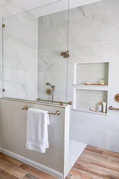 a bath room with a toilet and a shower head mounted to it's side