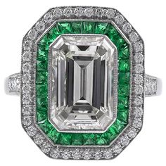 Sophia D's Art Deco inspired platinum ring that features an emerald cut diamond weighing 2.84 carats accented by small round diamonds with the total weight of 0.31 carat and French cut green emeralds weighing 0.50 carats. Sophia D by Joseph Dardashti LTD has been known worldwide for 35 years and are inspired by classic Art Deco design that merges with modern manufacturing techniques. Diamond Emerald Ring, Pink Sapphire Band, Emerald Cut Diamond Engagement, Emerald Cut Diamond Ring, Platinum Diamond Rings, Diamond Engagement Wedding Ring, Emerald Diamond Ring, Emerald Cut Diamond, Deco Engagement Ring