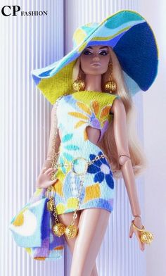 a barbie doll wearing a colorful dress and large hat with gold jewelry on her head