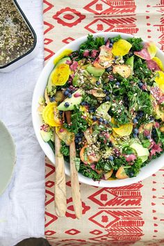 a white bowl filled with salad on top of a table