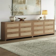 a living room scene with focus on the sideboard and large painting in the background