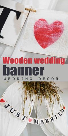 wooden wedding banner with red heart hanging from the ceiling and just married sign on it