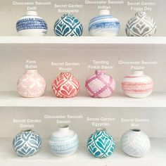 several different vases on shelves with names