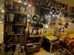 a room filled with lots of musical instruments and bookshelves covered in lights, posters and pictures