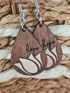 Laser cut wooden earrings with Tulip inlay.  Stained and wax sealed. Nickel -free silver plated hardware.  I created these for Parkinsons Awareness Month. I was diagnosed 5 years ago with Early Onset. It was and still is a struggling diagnosis. These earrings are meant to remind us to always have hope even on the dark days! I truly believe this is not only true for Parkinsons but many other challenges as well Teardrop Wooden Earrings For Gifts, Teardrop Wood Earrings For Gifts, Wooden Teardrop Earrings For Gift, Wooden Teardrop Earrings As Gift, Teardrop Wood Jewelry Gift, Parkinsons Awareness Month, Parkinsons Awareness, Tulip Earrings, Dark Days