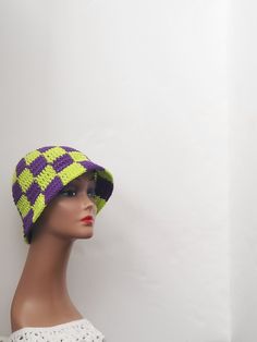 Crochet checkered bucket hat Get ready for your next festival with this handmade checkered bucket hat! The purple and neon green colors give it a unique and eye-catching look that is perfect for a boho or hippie chic style. Made with lightweight and stretchy acrylic crochet fabric, it is comfortable to wear in any season - whether it's winter, summer, fall, or spring. This one size fits all hat is perfect for casual occasions and features accents that give it a stylish touch. The hat is not only fashionable but also practical as it is handmade with high-quality materials. Add this United States made bucket hat to your wardrobe and show off your love for checkered patterns and hippie fashion! Green And Purple Crochet, Purple And Neon Green, Hippie Chic Style, Checkered Bucket Hat, Crochet Checkered, Hippie Chic Fashion, Purple Crochet, Hippie Fashion, Crochet Fabric