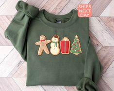 a green shirt with ginger, snowman and christmas cookies on it's chest